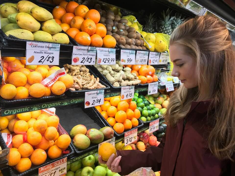 woman looking at fruit